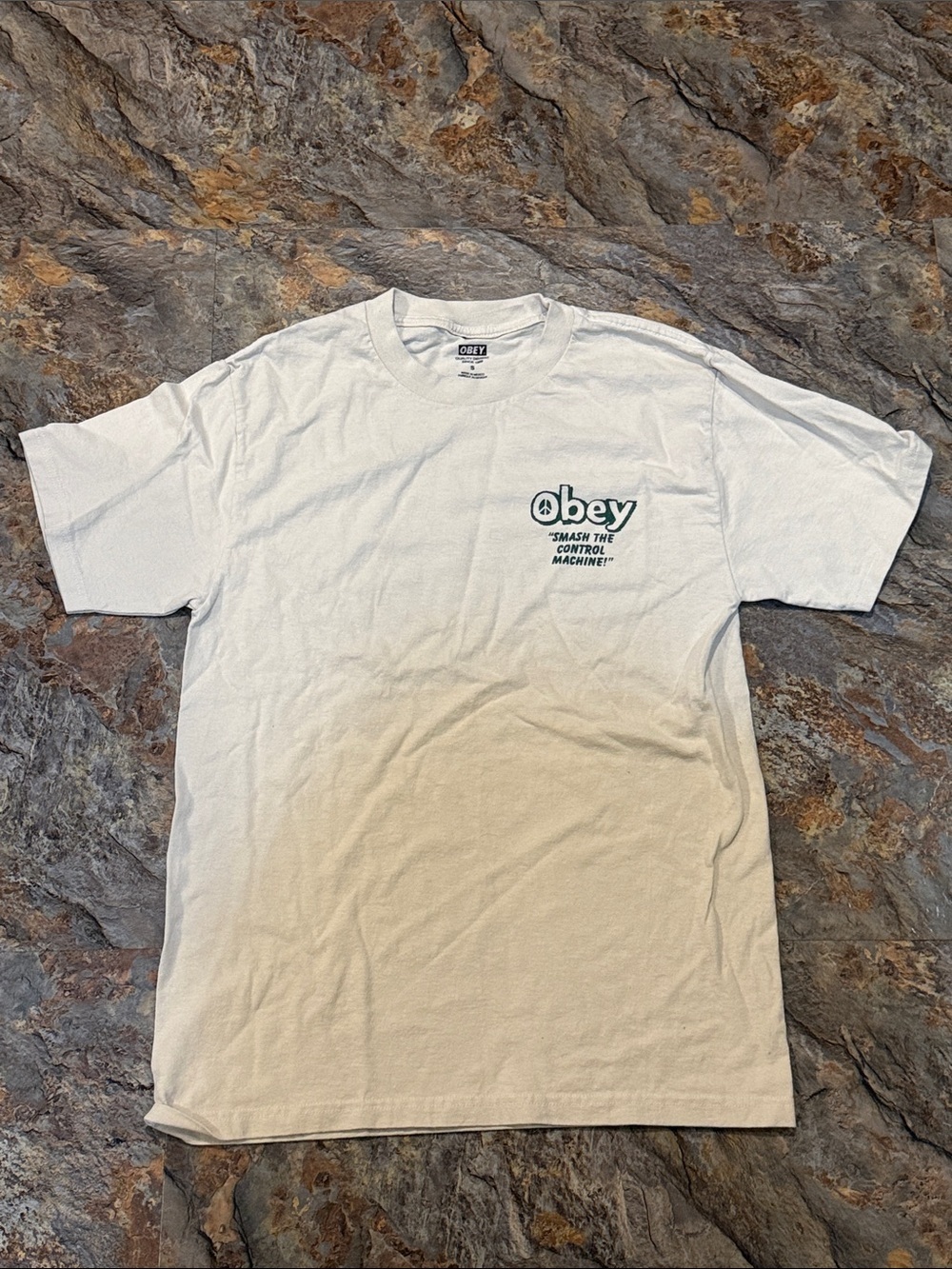 Obey beige/cream colored Tee with men’s size Small